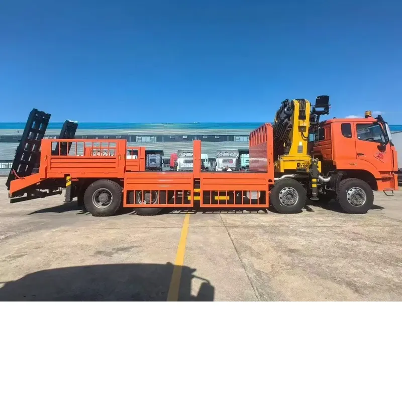 Side view of the HOWO 8x4 truck-mounted crane with the XCMG knuckle-boom crane folded above the flat-bed body and the loading ramps stowed at the rear
