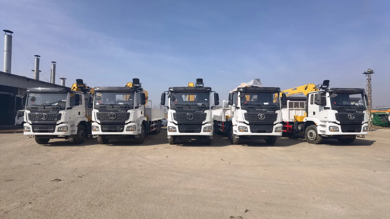 Batch of five SHACMAN Delong H3000S 6x4 truck-mounted cranes with XCMG SQS300-4 cranes, lined up at the works