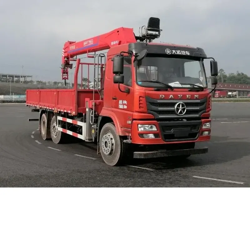 Red Dayun truck-mounted crane with the crane boom folded down, three-quarter front view in a truck yard