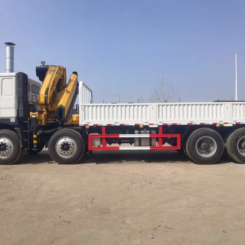 Knuckle-boom truck-mounted crane on a white SHACMAN 6x4 chassis, folding boom stowed, side view at the works