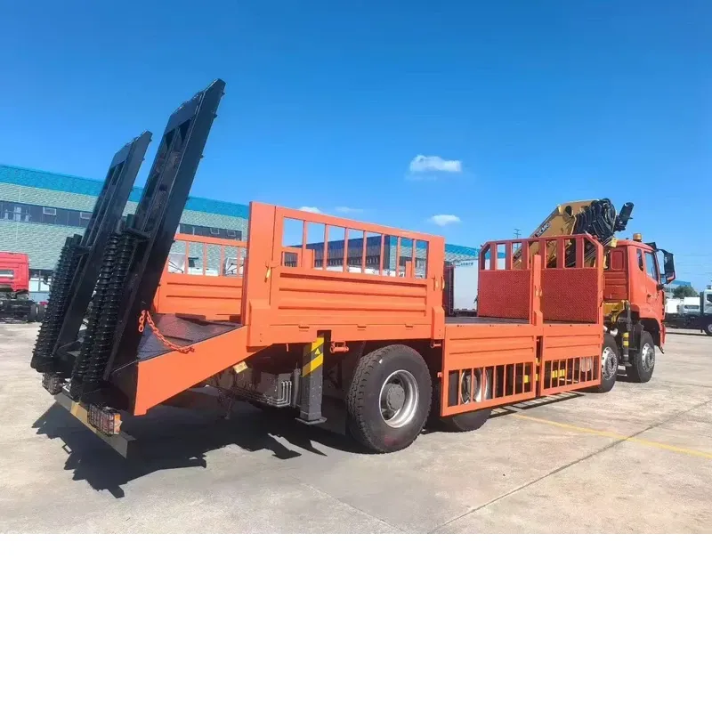 Rear three-quarter view of the HOWO 8x4 truck-mounted crane showing the flat-bed body and the pair of folding loading ramps