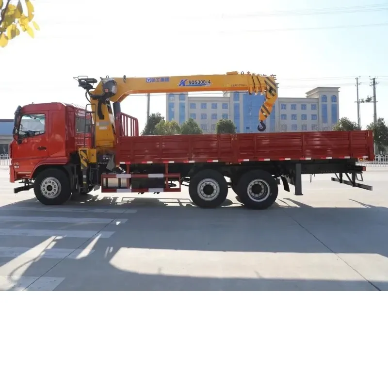 Opposite side view of the red Dayun crane truck with the yellow crane stowed over the cargo body