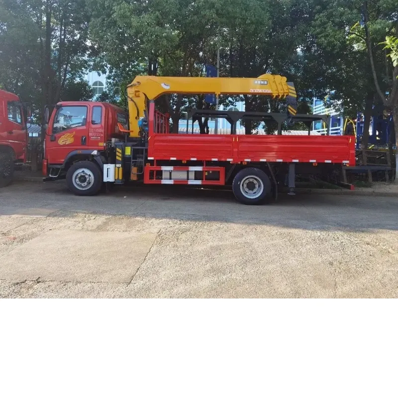 Side profile of the red Howman crane truck with the yellow knuckle-boom crane folded above the cargo body