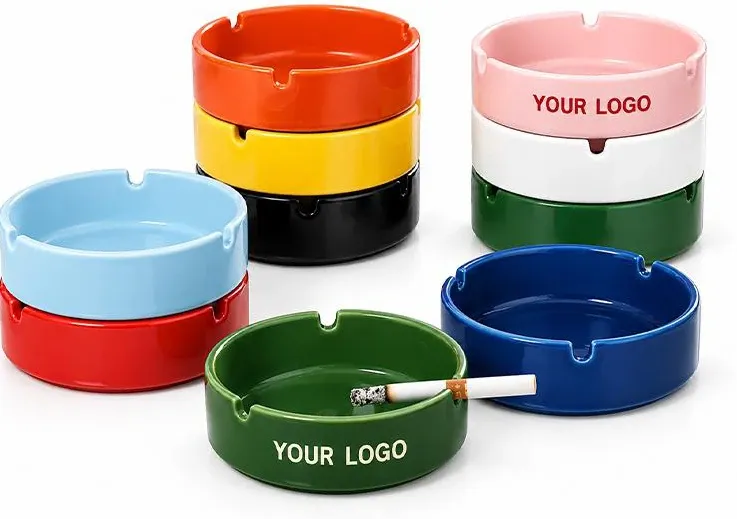 Round ceramic ashtrays with cigarette rests in bright colors, including examples with Your Logo lettering.