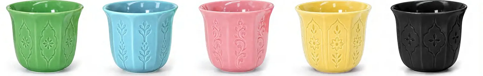 Five small handleless ceramic coffee cups with embossed patterns in green, blue, pink, yellow and black.