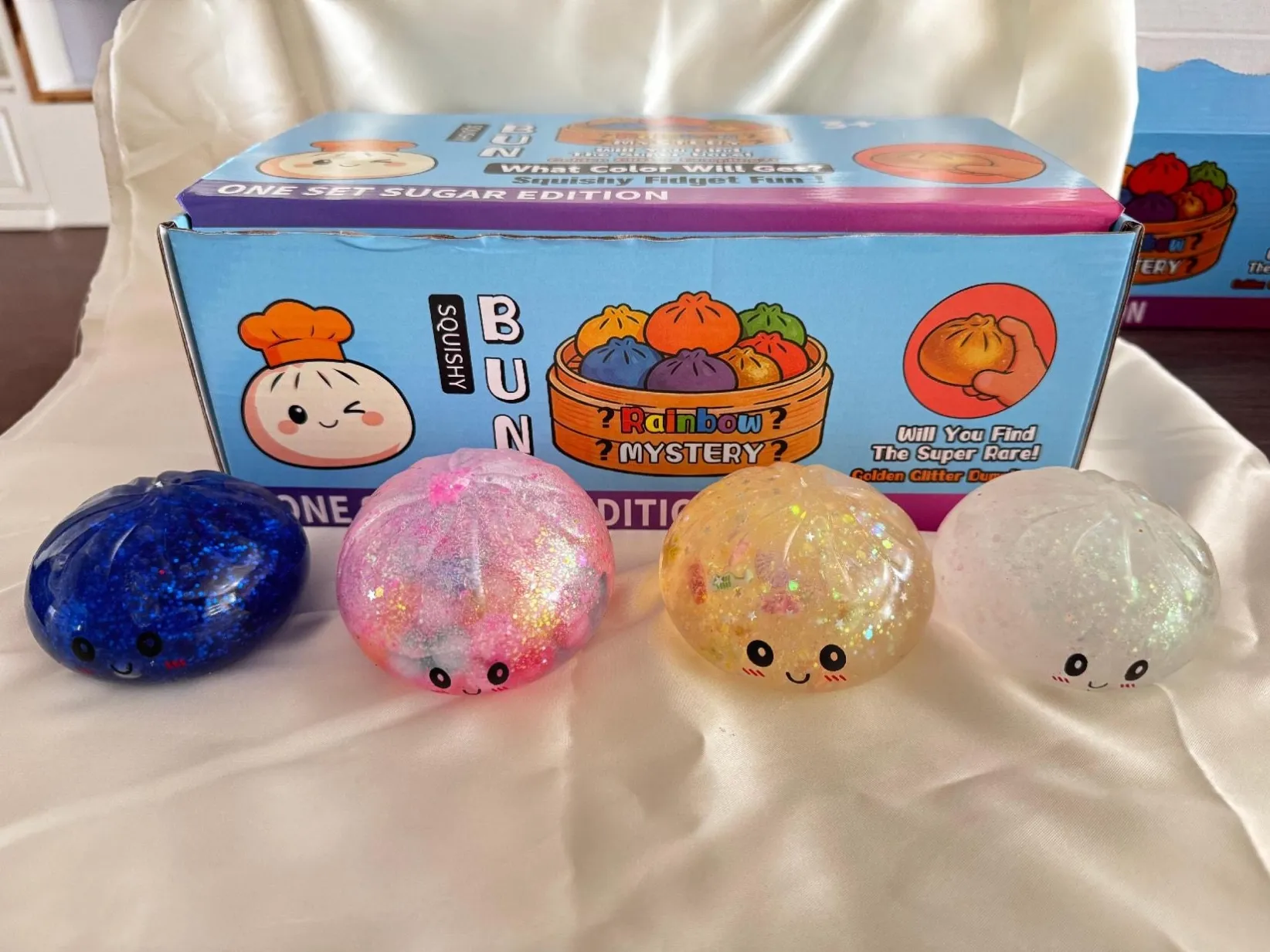 Clear colourful dumpling-shaped squishy toys with a display box