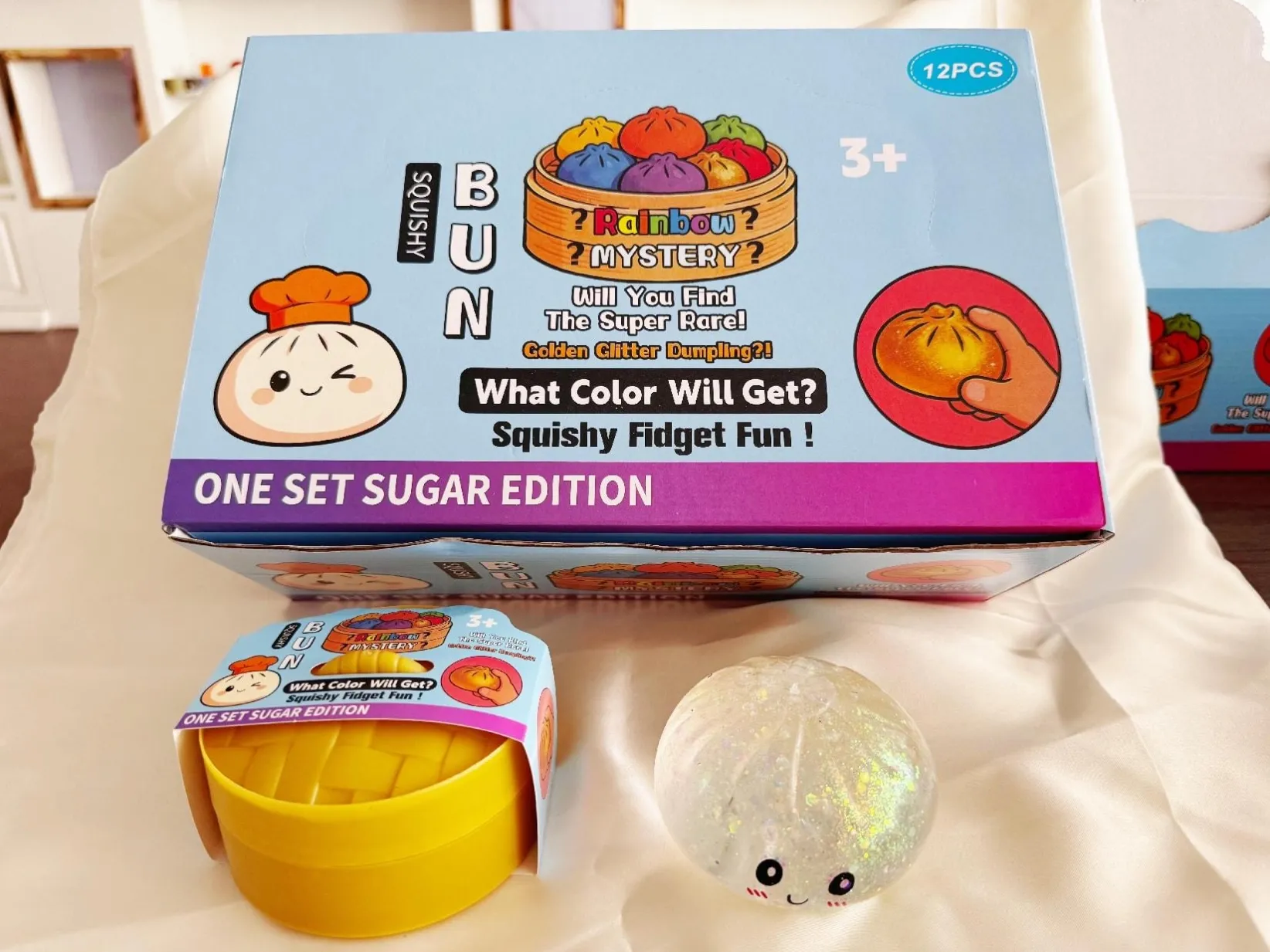 Dumpling-shaped squishy toy beside a small tub and display packaging