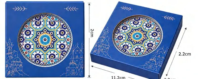 Blue geometric ceramic coaster shown with two styles of individual blue gift packaging and printed dimensions.