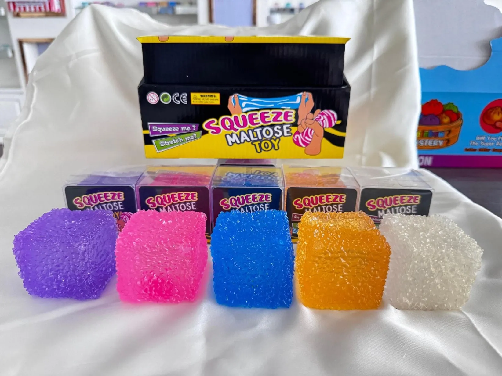 Colourful squishy cubes with a textured appearance and display packaging