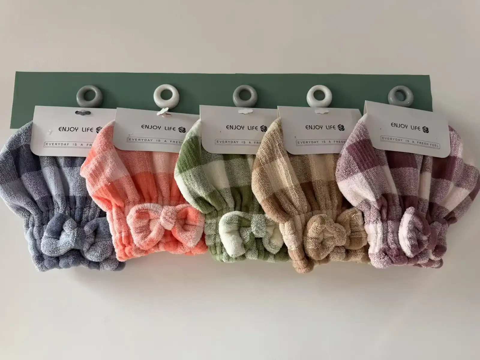 Grid-patterned compact hair towel caps in assorted colors with hanging cards