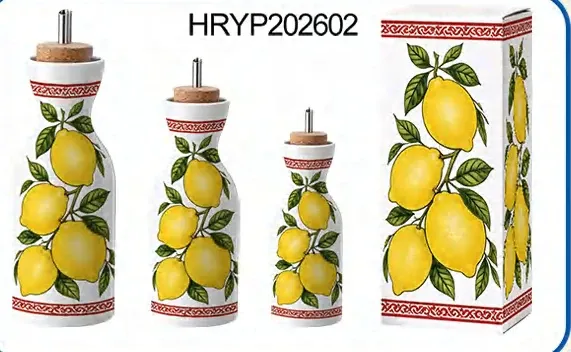 Three cylindrical ceramic oil bottles in different heights with lemon artwork, metal pour spouts and a matching gift box.