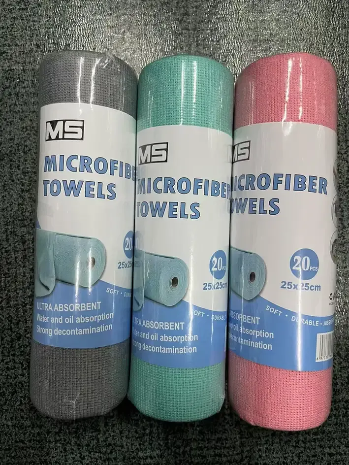 Green, blue and red tear-off cleaning cloth rolls in retail wrapping