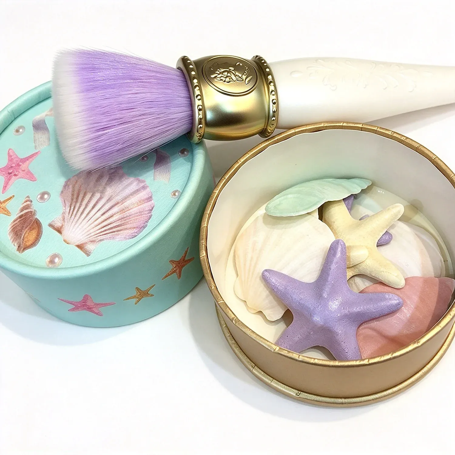 Seashell shaped blush in a shell printed tin with a gold brush