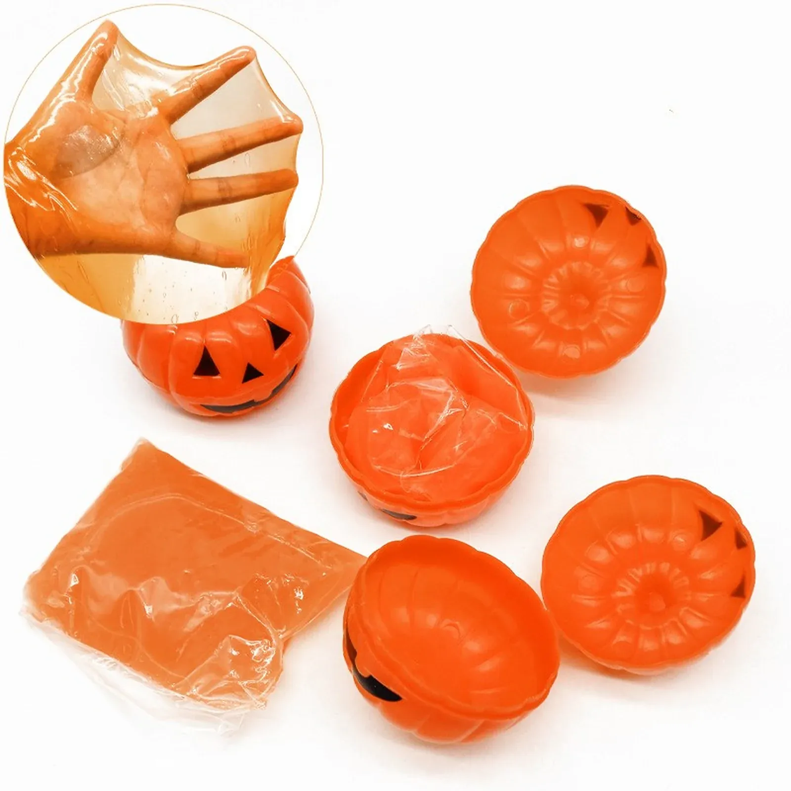 Pumpkin Slime Pots - Five orange pumpkin-shaped cups, two showing jack-o'-lantern faces and one open with a clear bag of glossy orange slime.