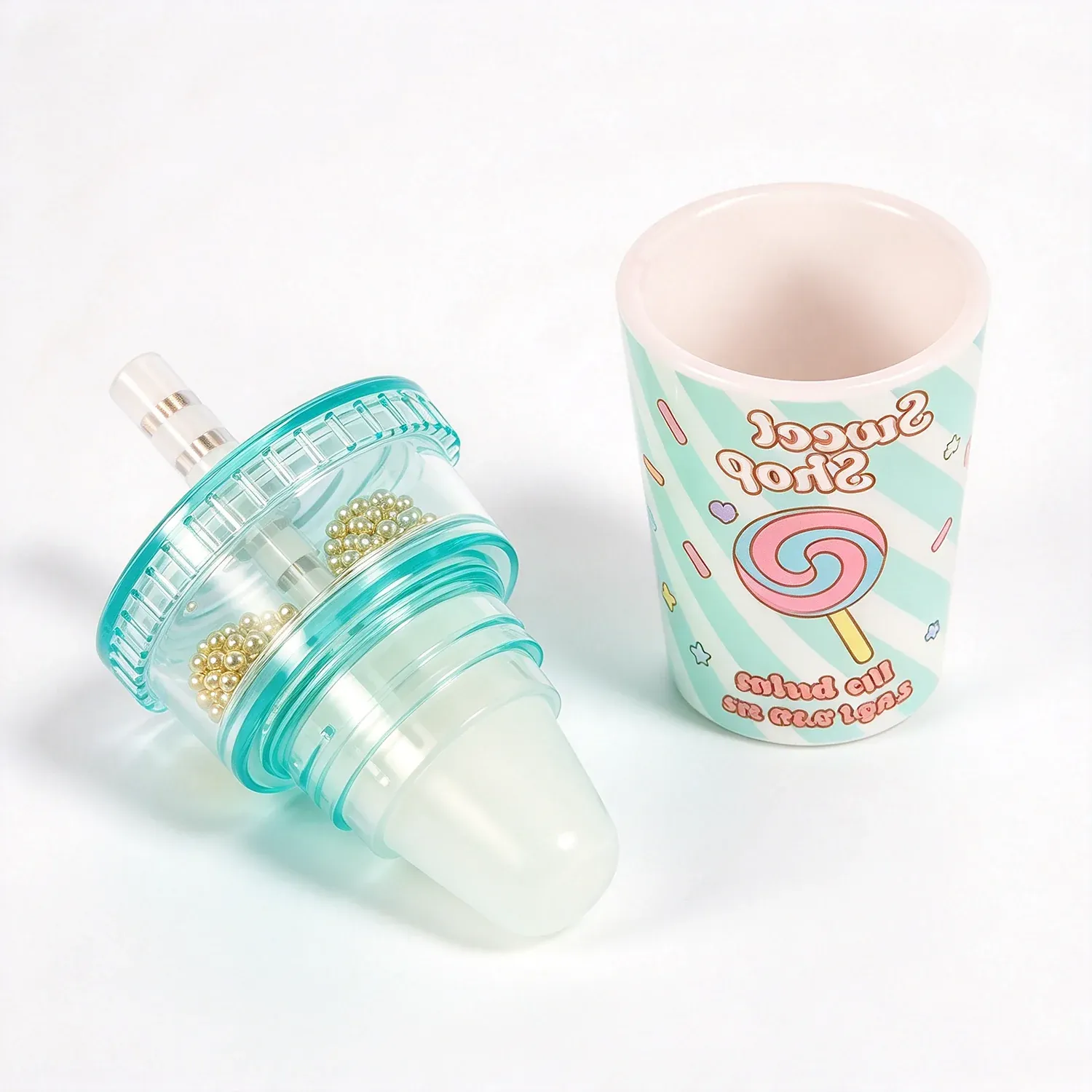 Baby bottle shaped lip gloss with a printed cup beside it
