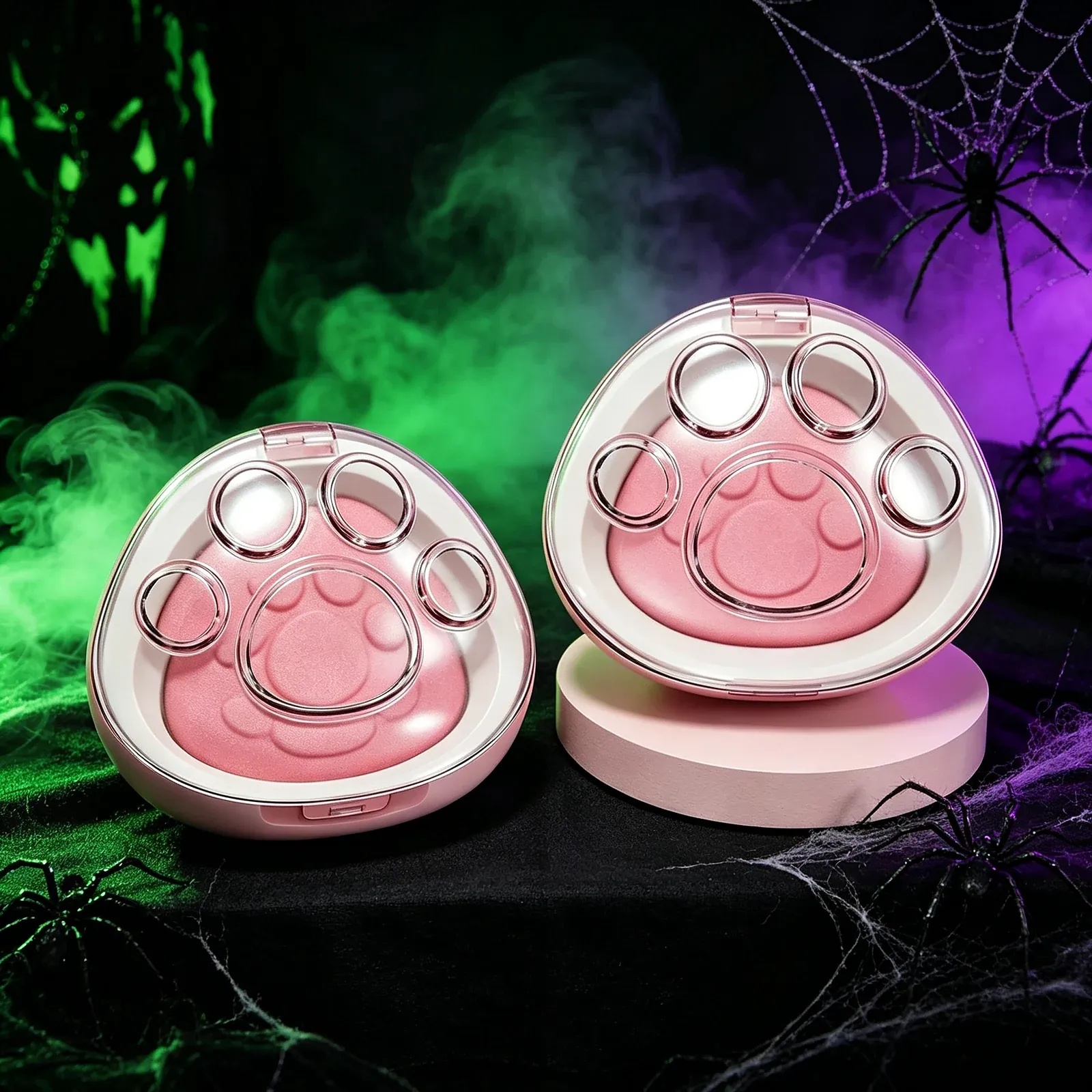 Paw Print Blush Compact - Two pink paw-shaped compacts with a large embossed paw print in the powder, both open to show a pink blush pan in a clear-lidded white case.