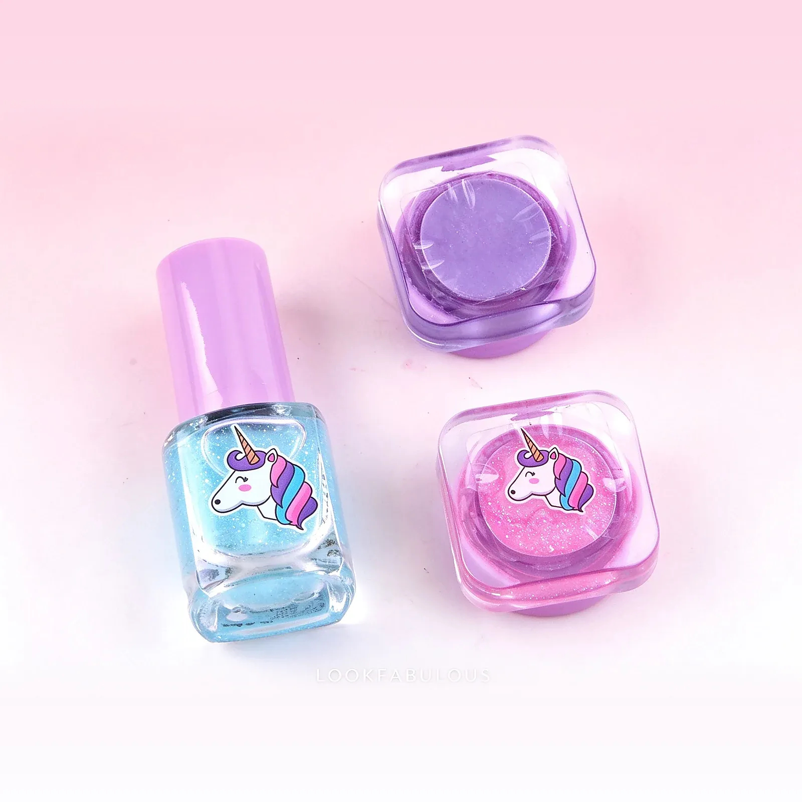 Blue square unicorn nail polish and two rounded square unicorn pots in purple and pink