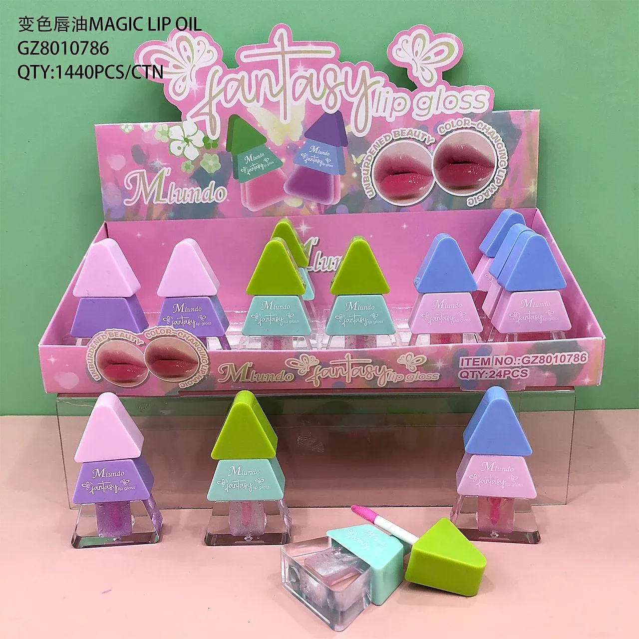 Counter display of triangle-capped lip gloss bottles with a printed colour-change panel