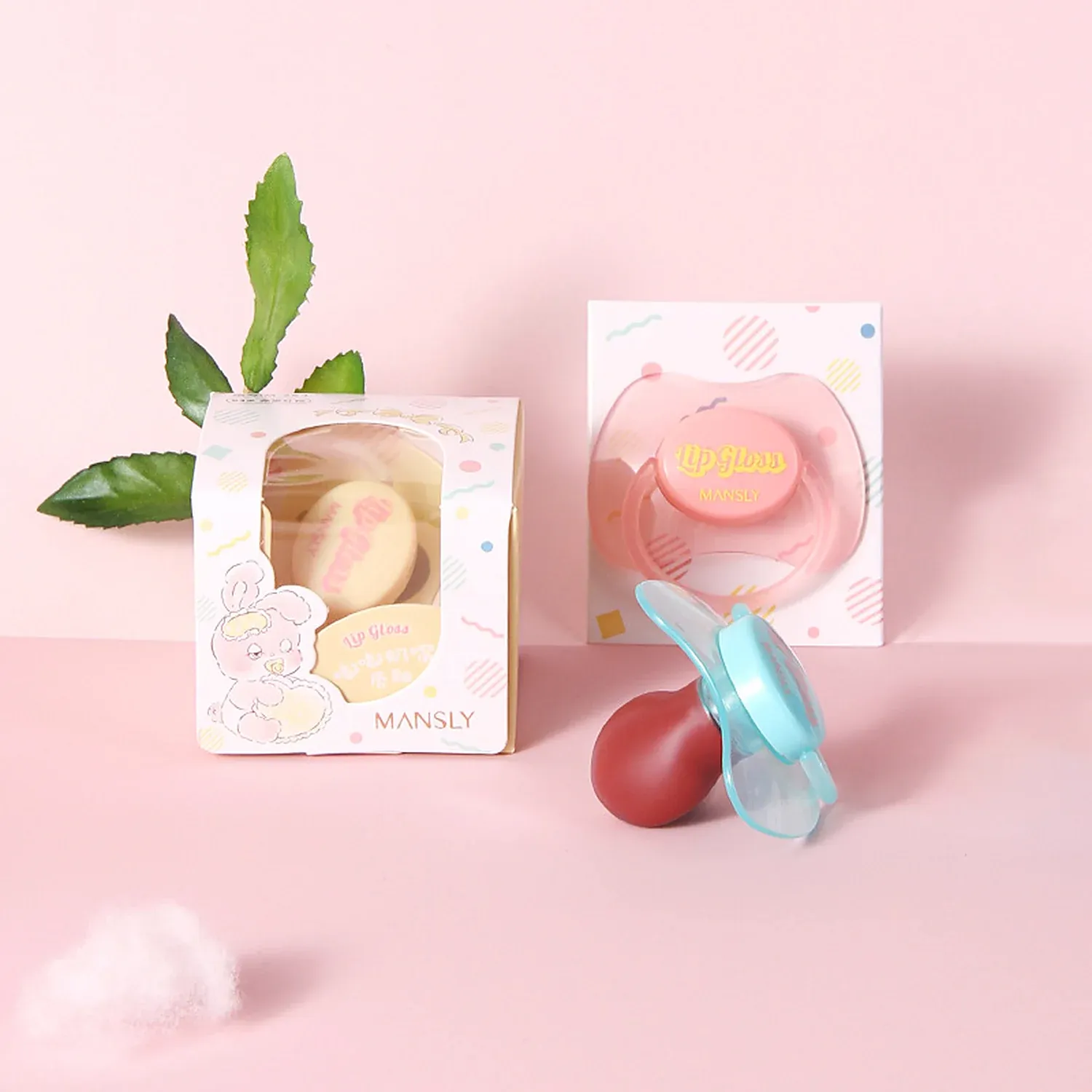 Three dome-shaped lip glosses with character tops in pink, blue and yellow