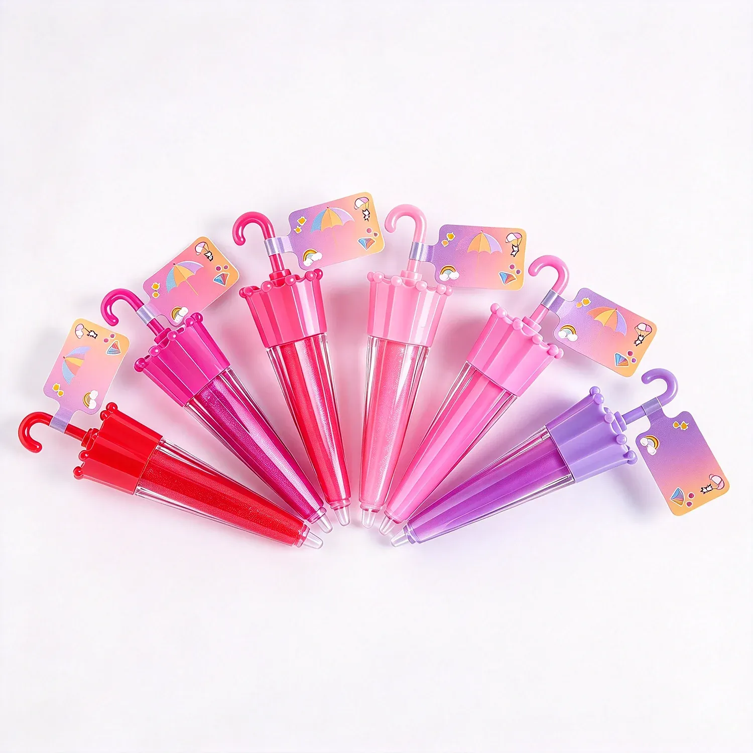 Fan of bow topped lip gloss keychains in pink and lilac