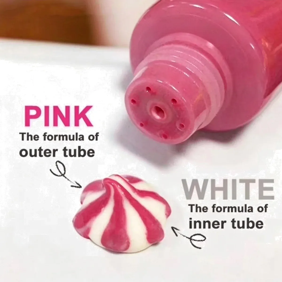 Pink hand cream tube with a two-tone pink and white cream swirl