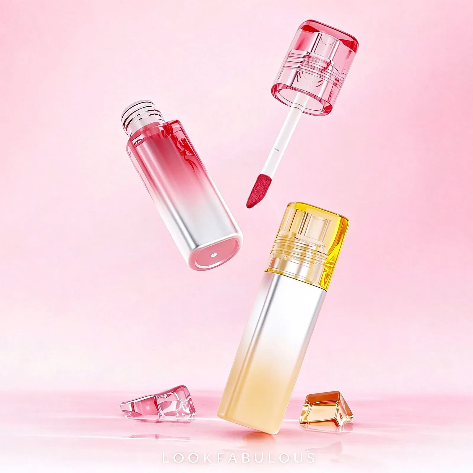 Two ombre lip gloss tubes fading from pink to silver and from yellow to silver