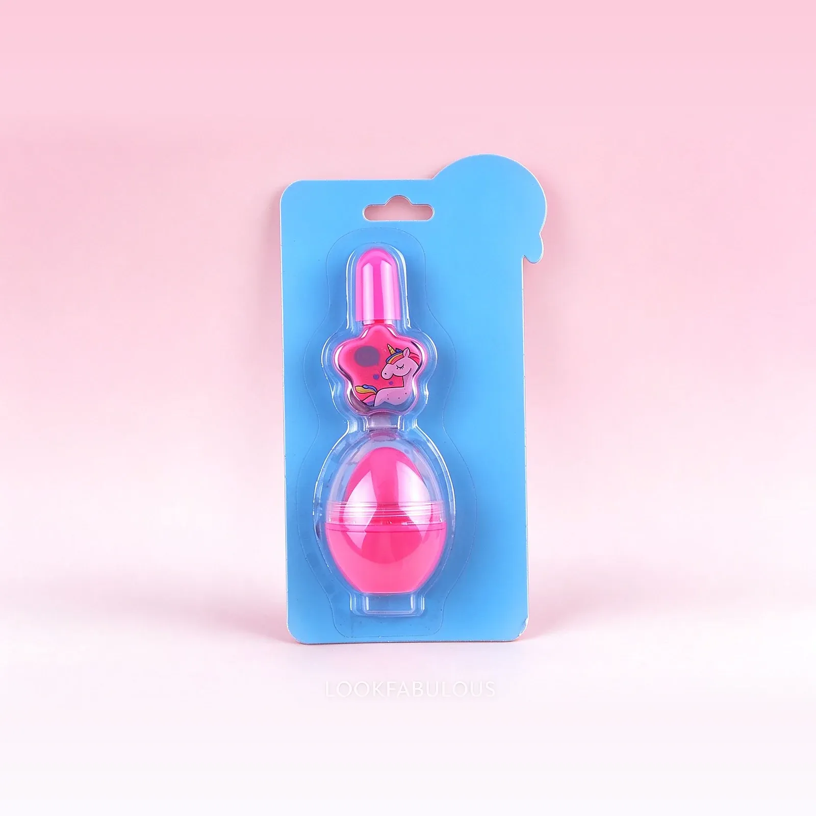 Blue unicorn-head blister card holding a pink unicorn-print nail polish bottle and a pink egg-shaped pot