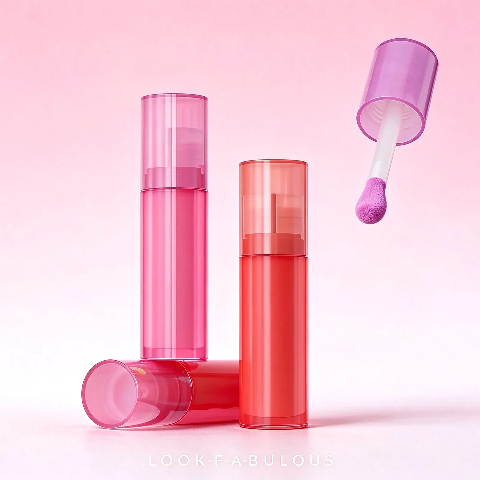 Slim clear liquid blush tubes filled with pink, coral-red and magenta colour, one with a wide doe-foot wand