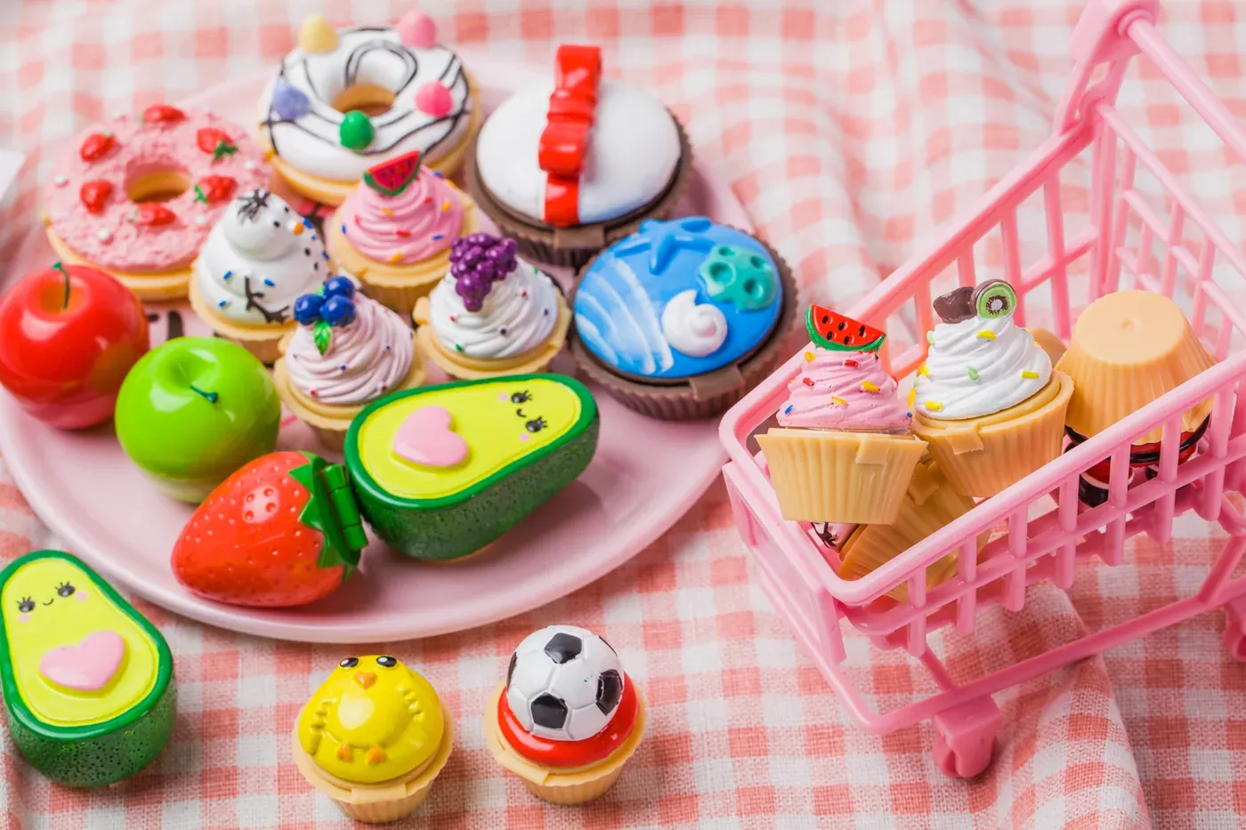 Cute food-shaped makeup with pink shopping cart on pink cloth