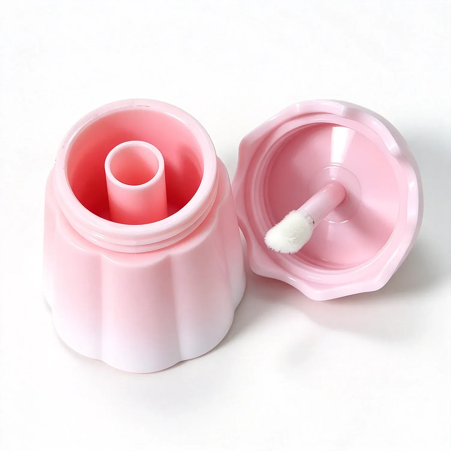 Round pink pot of gloss with a small lip brush inside