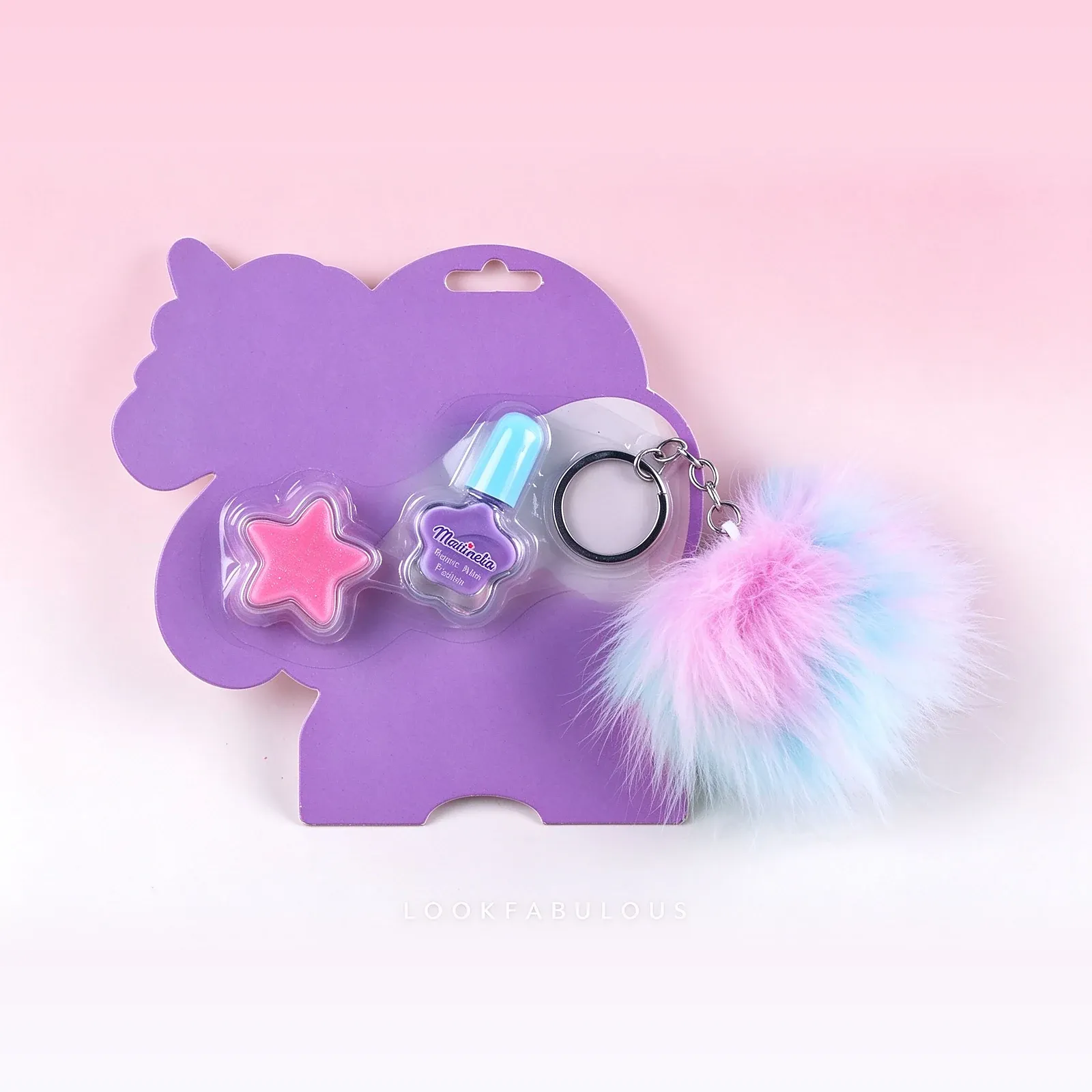 Front view of the unicorn card set with the star polish, purple bottle and pom-pom keychain