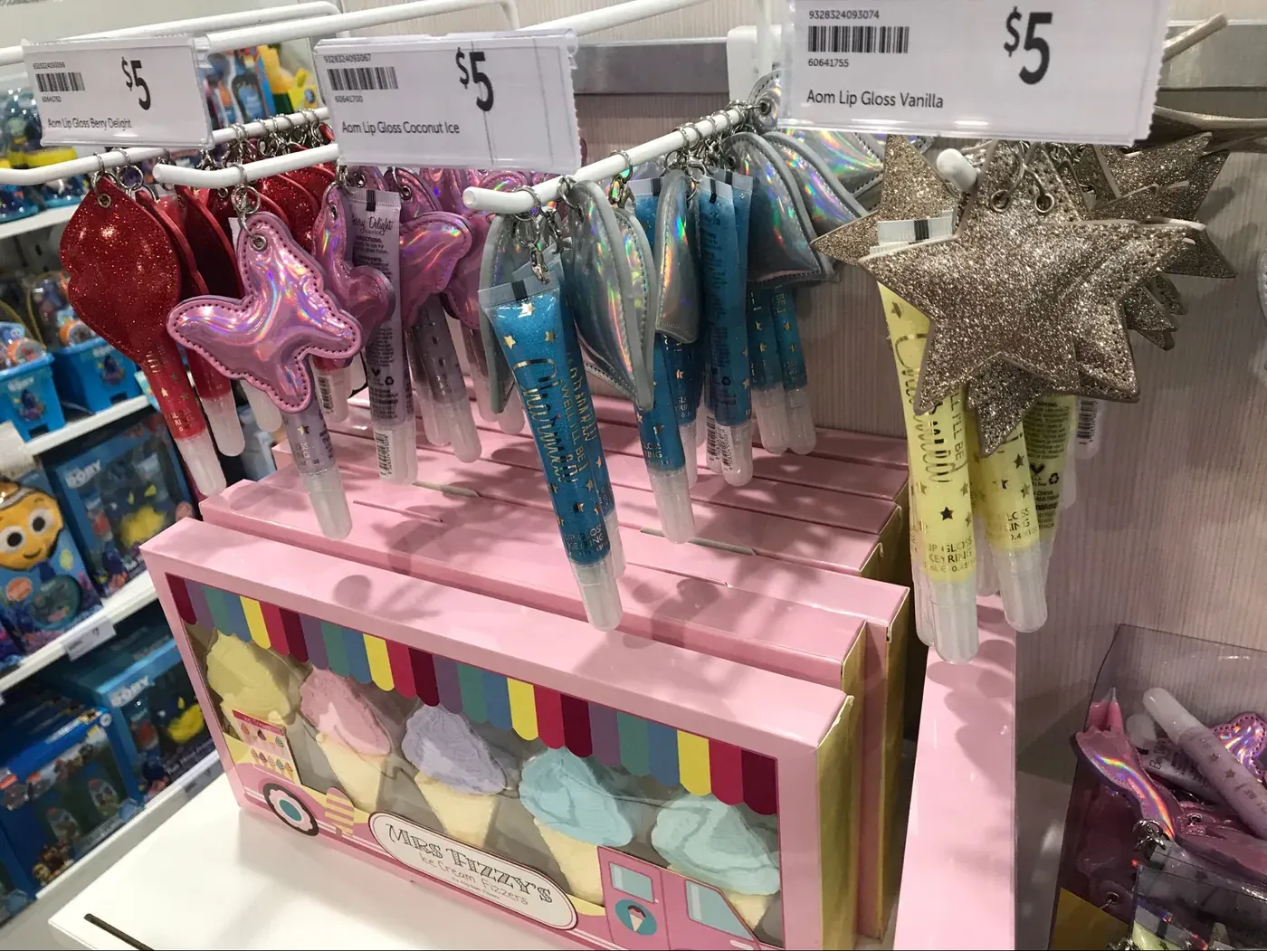 Star-shaped lip glosses with price tags on a store display