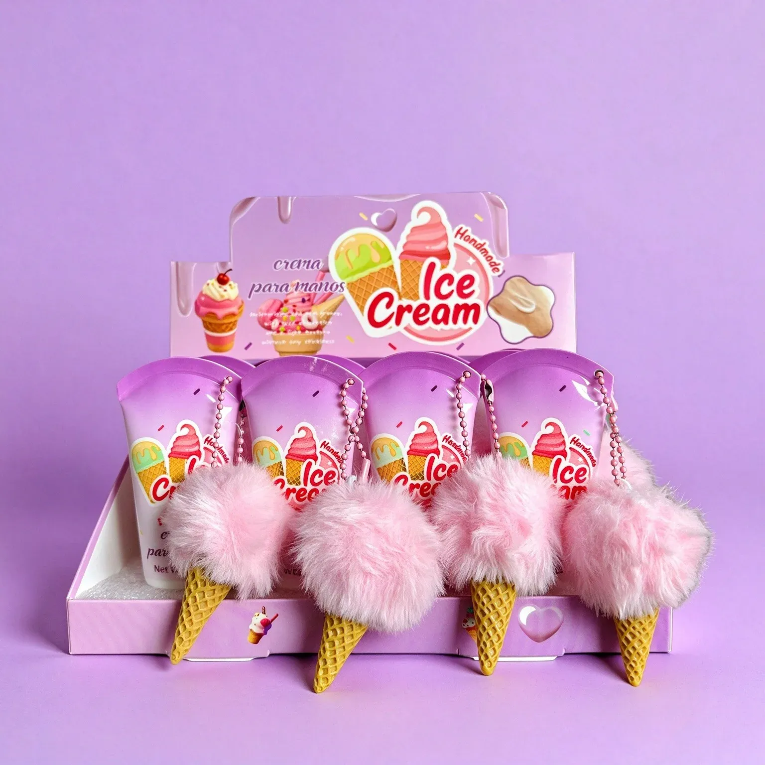 Ice cream hand cream tubes with pink pom-poms and cone charms in a purple display box
