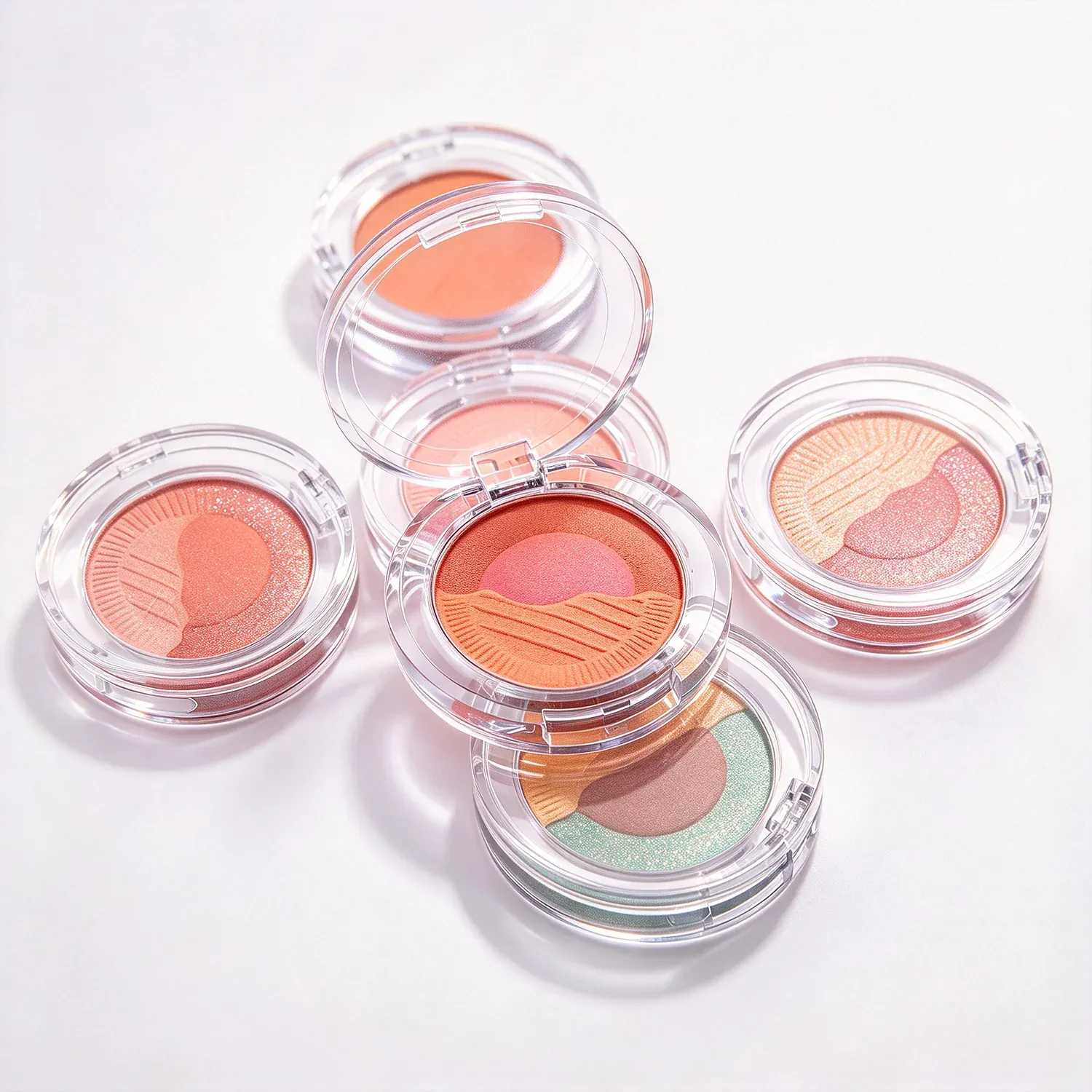 Round clear pots of loose blush with a single pan