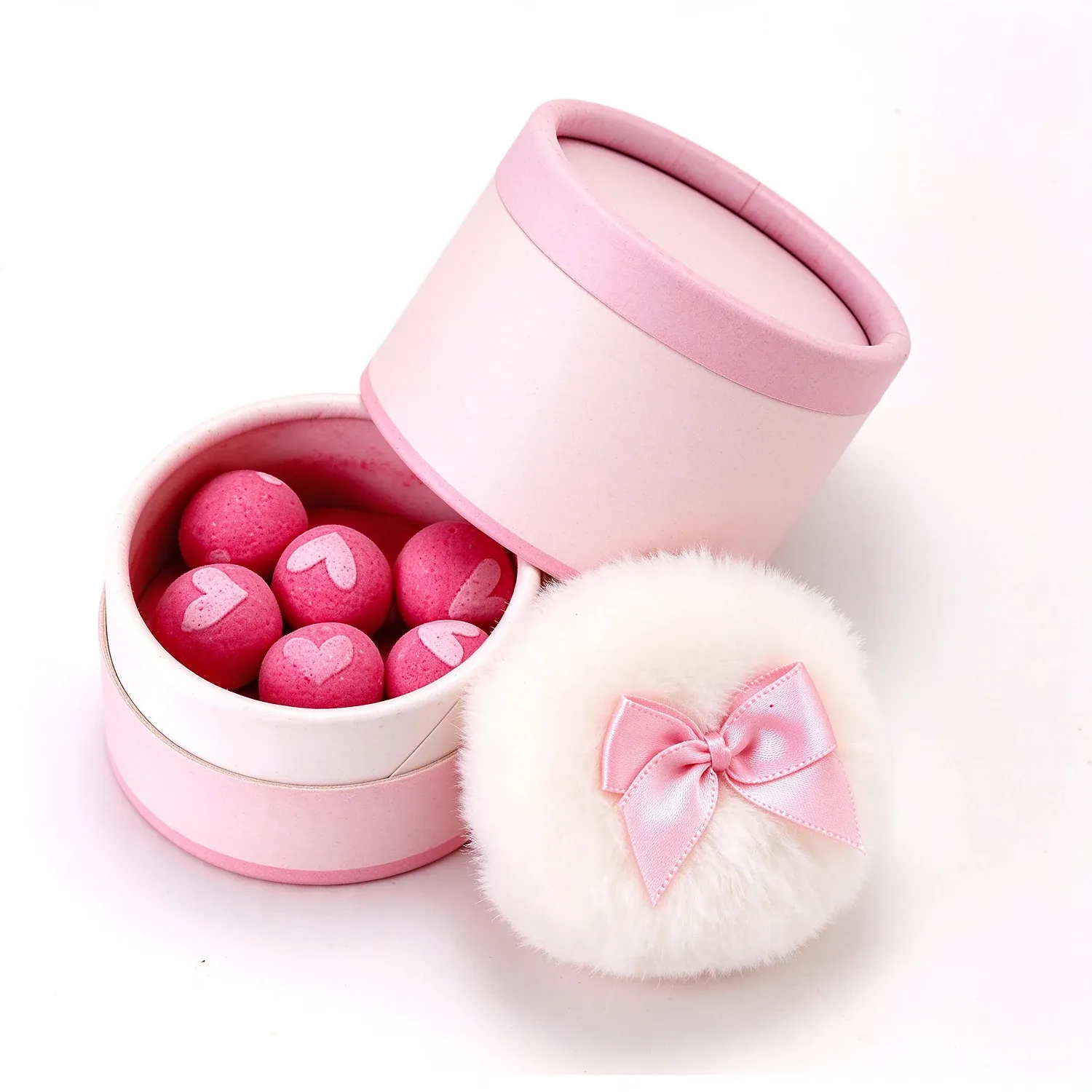 Pink heart-printed blush balls in a round pink box with a fluffy puff