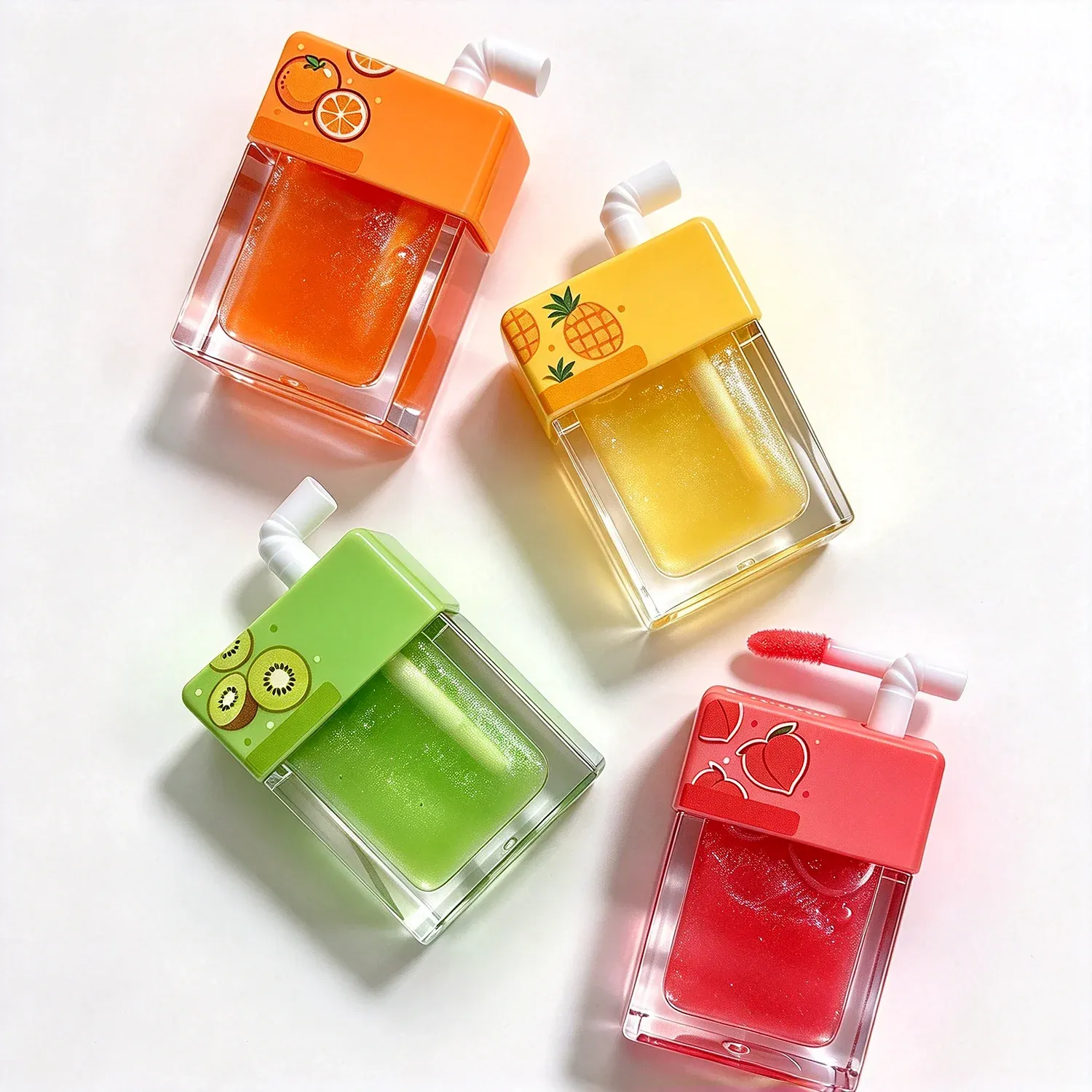 Four square juice box shaped lip glosses with fruit prints