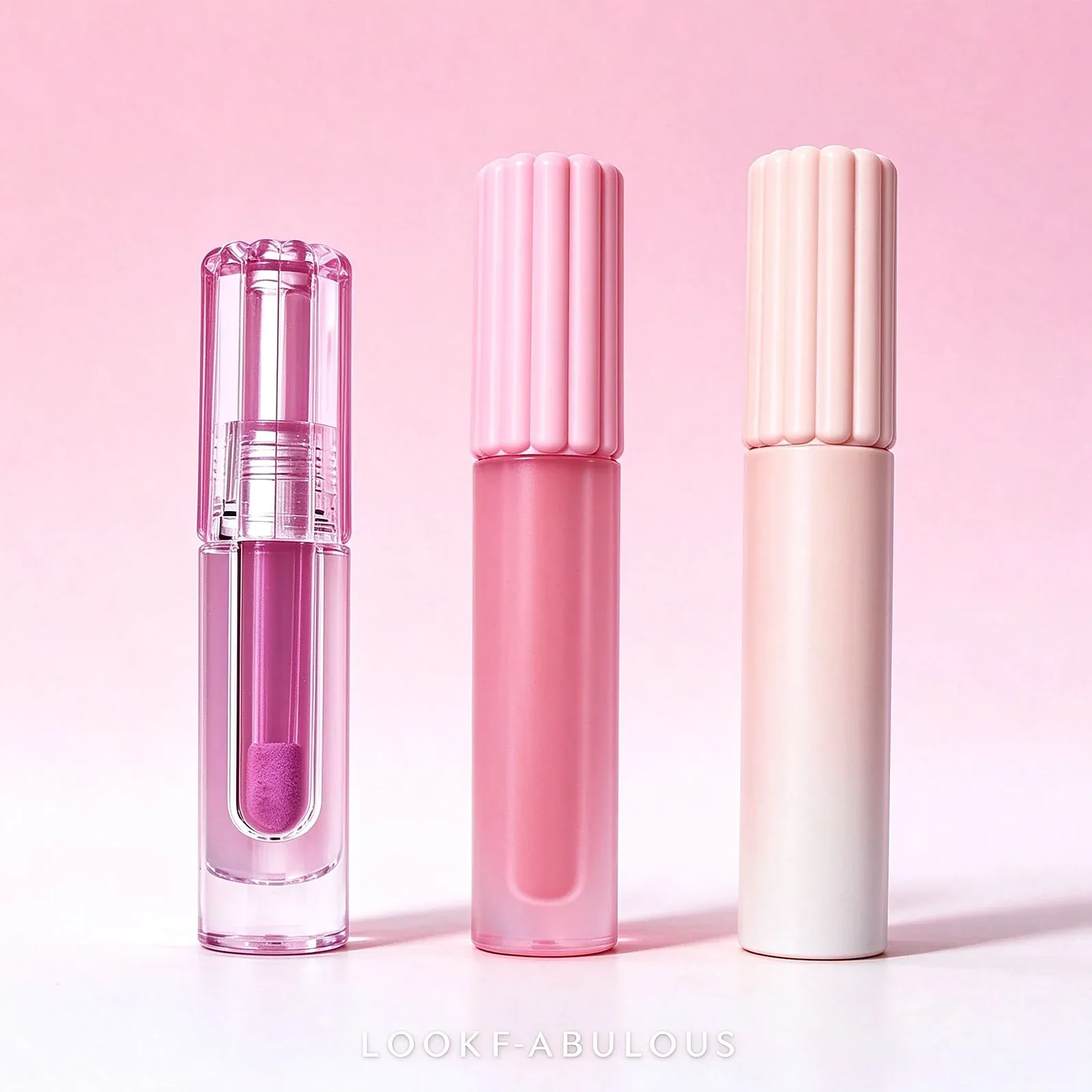 Three lip tubes in clear pink-violet gloss, matte pink and cream finishes with doe-foot wands