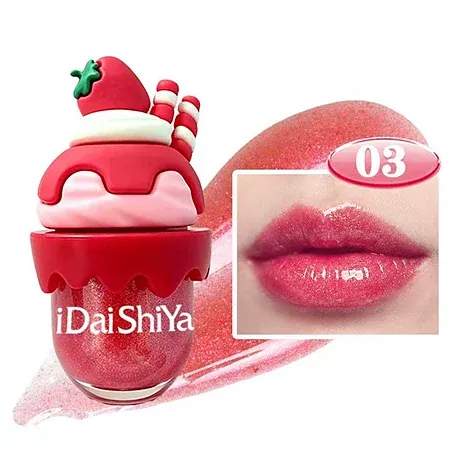 Santa hat lip gloss bottle shown with a lip swatch