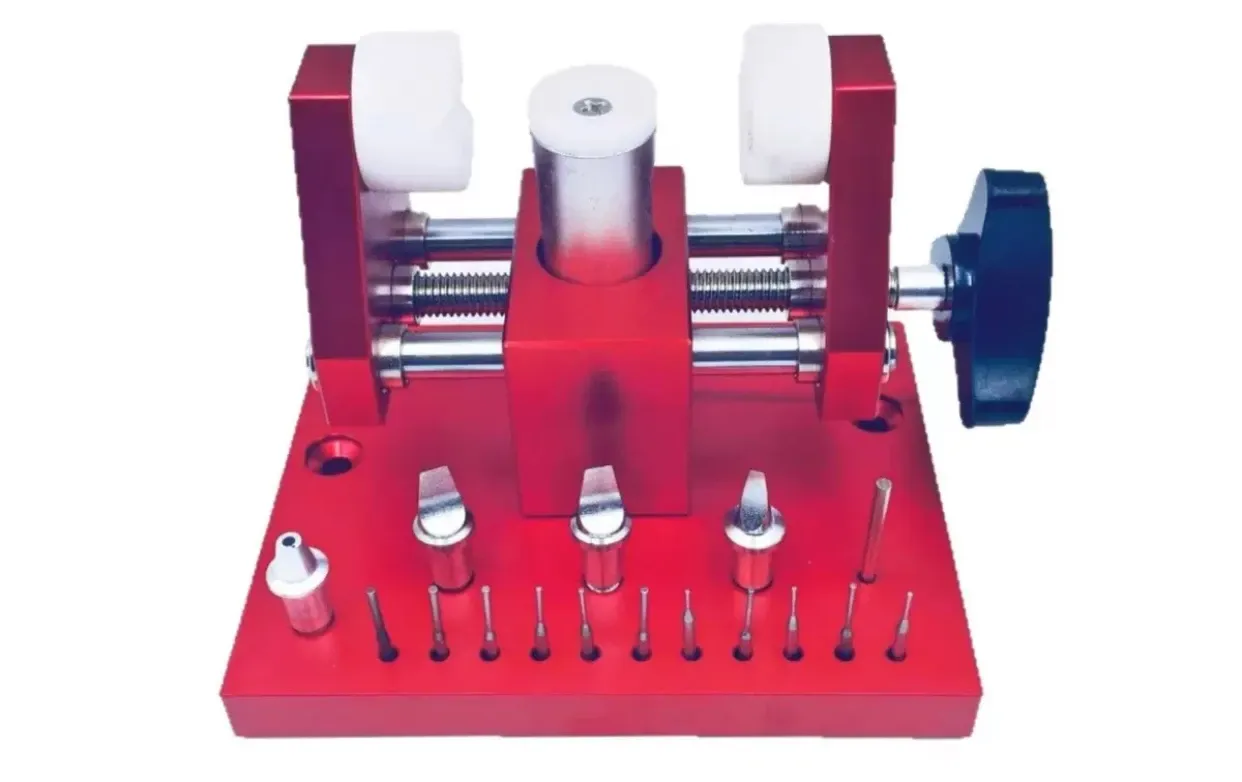 Red multi-use watch pry tool with a blue clamping knob, front view