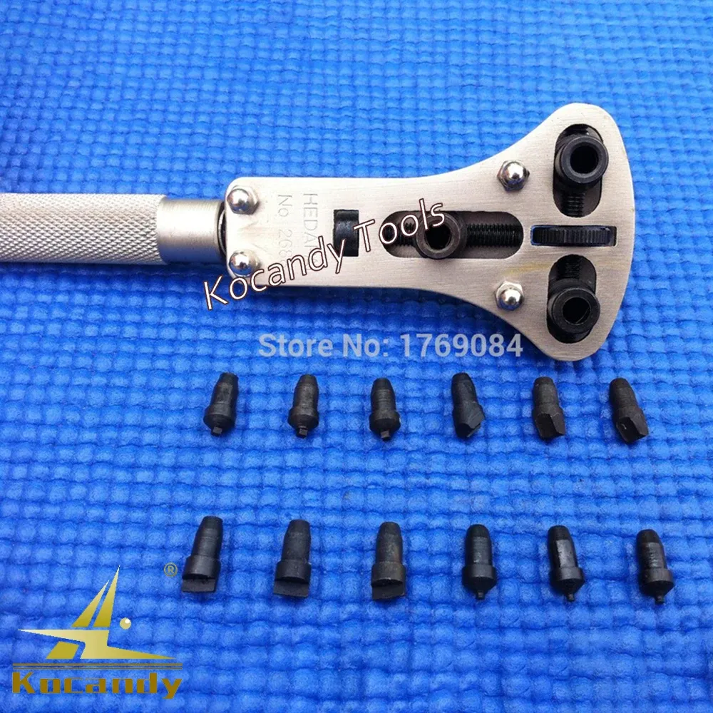 Adjustable case wrench shown from above with spare dies on blue