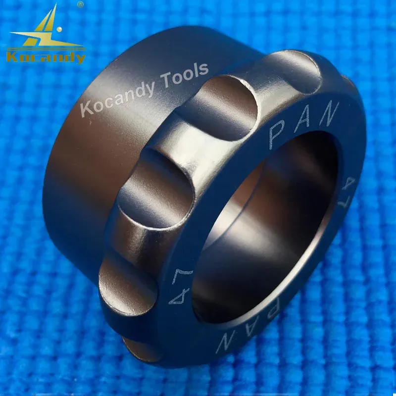 Two round case opener dies for PAN47 shown on blue cloth