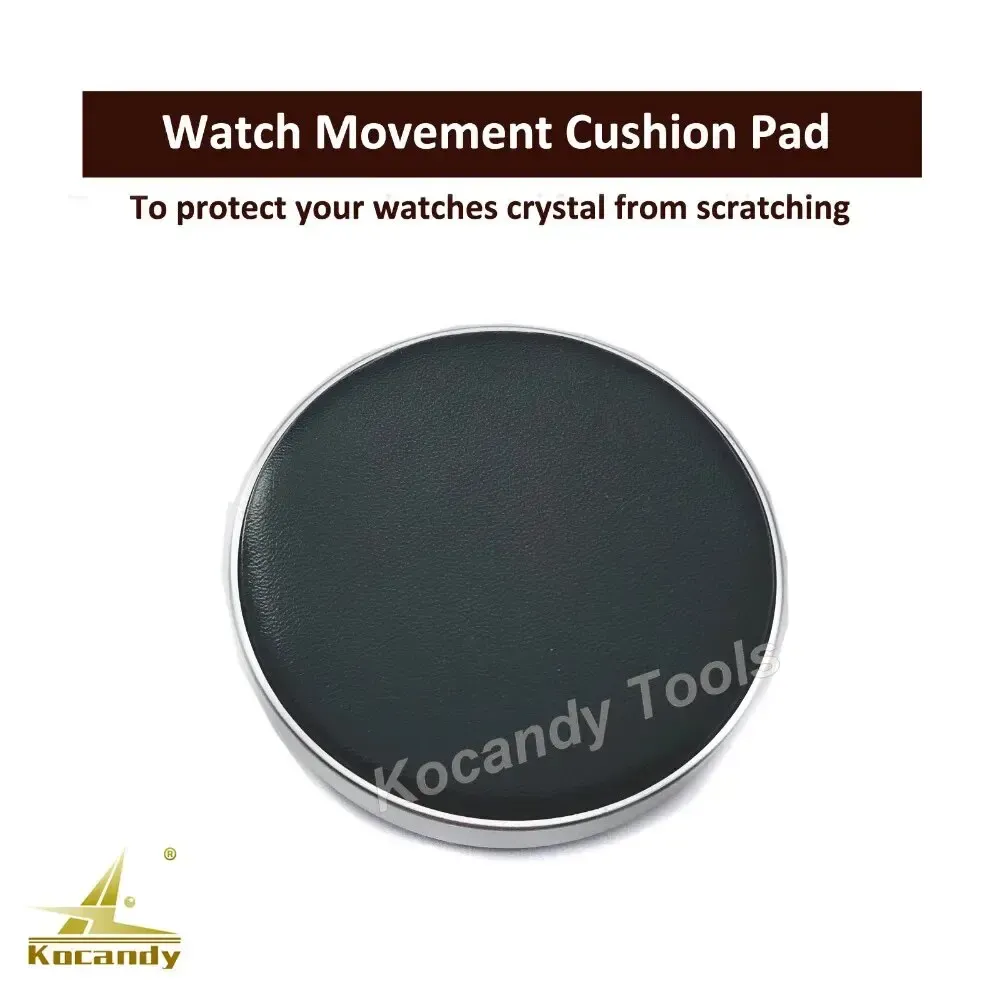 Black round gel cushion pad for watch crystal protection on a plain background