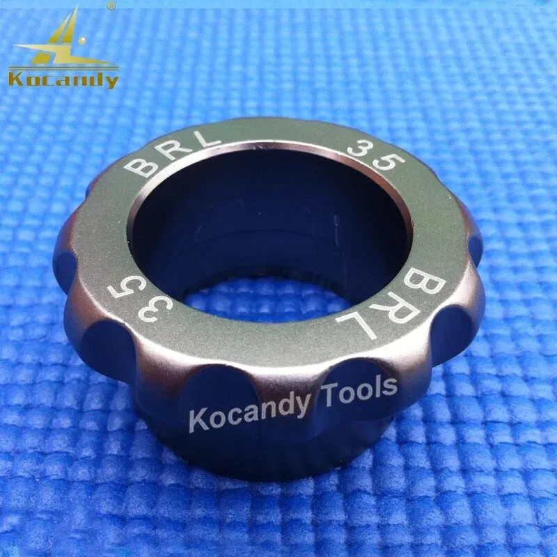 Black Breitling BRL 35 case opener die with notched edge on blue fabric