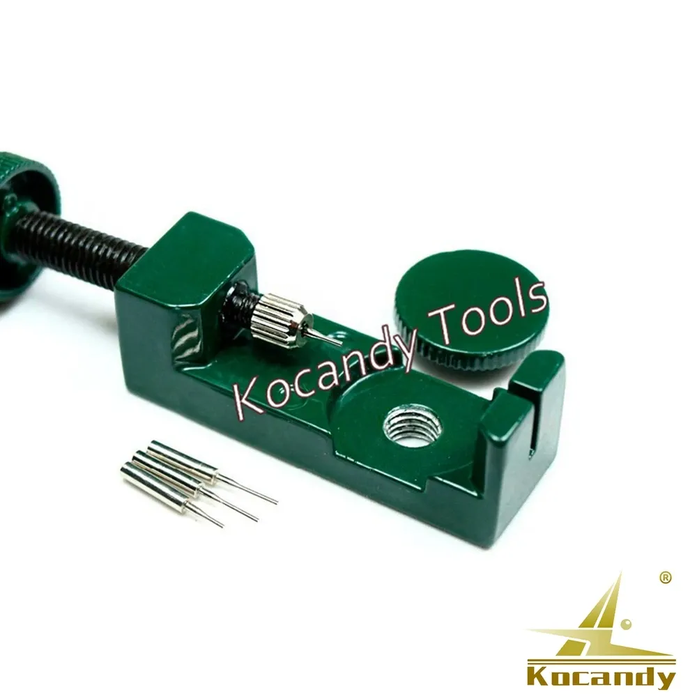 Green link remover with loose spare pins lying beside it