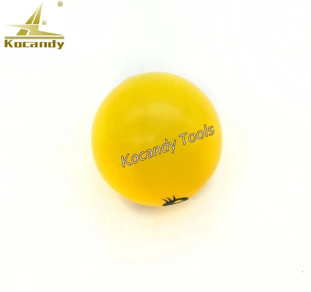 Yellow smiley silicone ball tool on a plain white background
