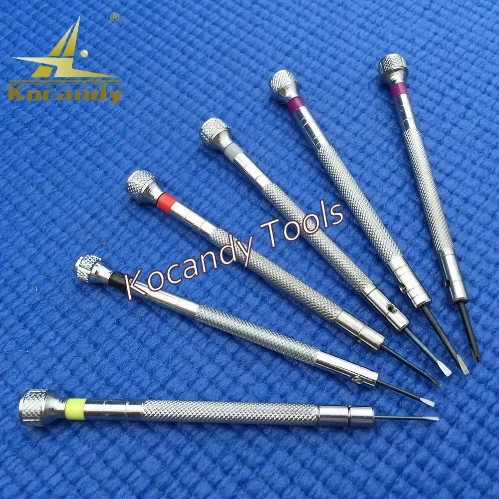 Fan of six thin screwdrivers on blue fabric showing narrow metal shafts