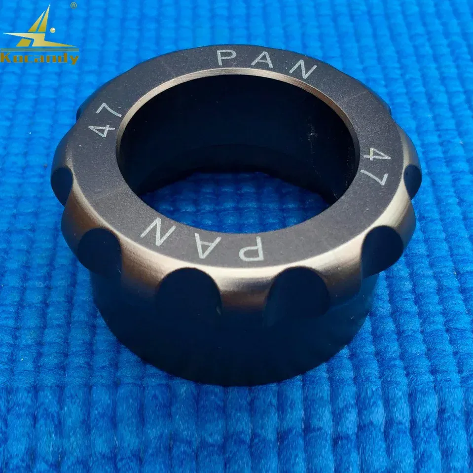 Dark steel opener die marked PAN around its rim