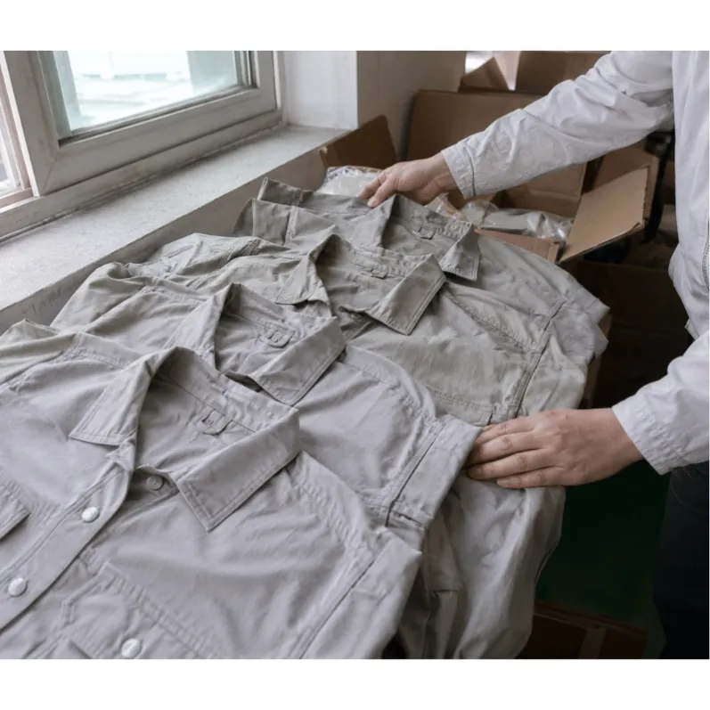 Garments from different cartons placed side by side under natural light for color shade comparison