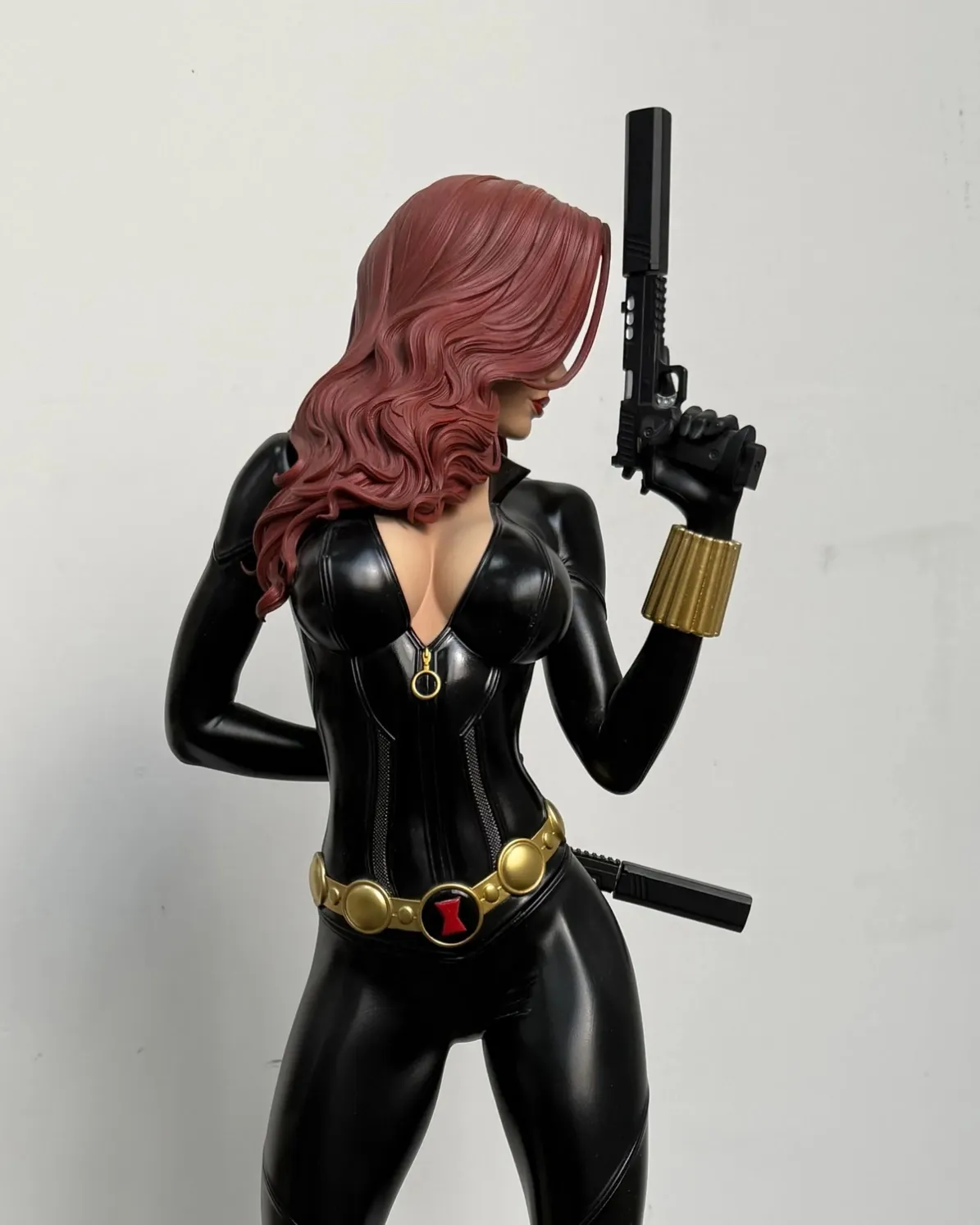 Sculpted reddish hair with defined flowing locks on a painted collectible statue.