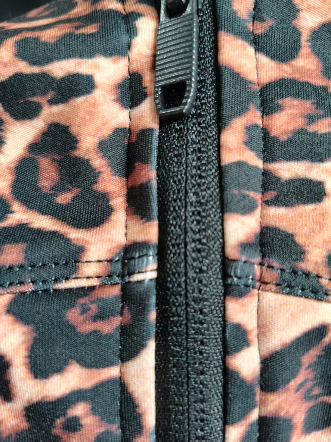 Clean zipper stitching detail on leopard print activewear jacket